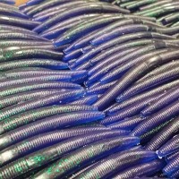 7 inch Salty Slings worm pile in color 076 Junebug Blue Tail